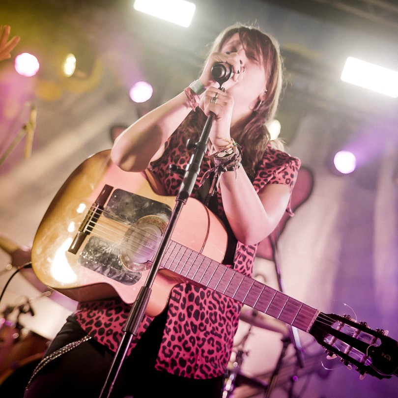 Las Locas del Panda en concert: veu i guitarra acústica sota els llums de l’escenari